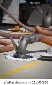 Fueling Truck With Drop Hose Connected To Underground Fuel Tank