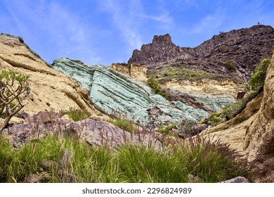 Fuente de los Azulejos seen from the road that leads from Mogán to the Aldea de San Nicolás. Emerald green rock formation in the mountains of the Inagua Integral Nature Reserve, in Gran Canaria.