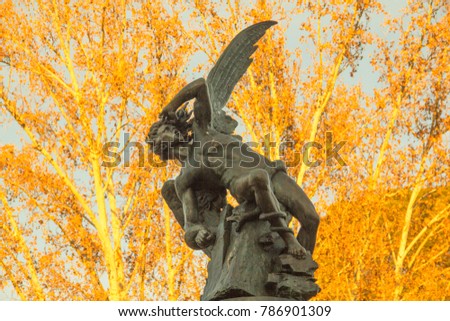 The Fuente del Ángel Caído (Fountain of the Fallen Angel) statue in Retiro Park, Madrid, Spain, representing the devil or Satan falling from heaven.