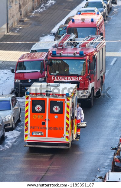 FUERTH / GERMANY -\
MARCH 4, 2018: German emergency service vehicles stands on street\
near an accident in a\
house