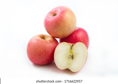 fuji apple cut in half isolated on white background with clipping path