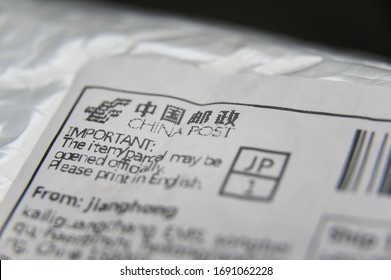 Fuji City, Shizuoka Prefecture, Japan - March 22, 2020: Bubble Wrap Padded Envelope With Close- Up On China Post Label. Isolated On Black Background.