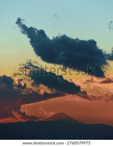 Fuji's grace — clouds dancing around the peak, breaking in the distance and shaping the sunset colours into a remarkable moment.