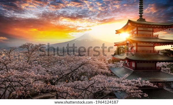 Fujiyoshida, Japan Beautiful view of mountain\
Fuji and Chureito pagoda at sunset, japan in the spring with cherry\
blossoms