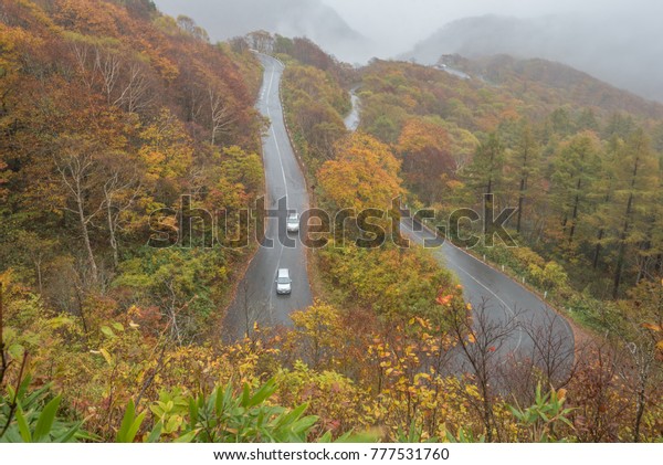 Fukushima,Japan -
October 20,2017 : The private car drive on Bandai azuma skyline at
Fukushima in autumn on raining
day.
