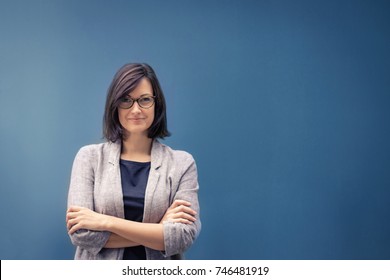 Fulfilled Businesswoman And Female Leader. Portrait Of Confident Female Entrepreneur With Arms Crossed Looking At Camera. Copy Space.

