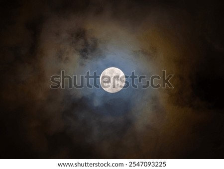 Full Beaver moon shining through the clouds November 2024 above Ottawa, Canada