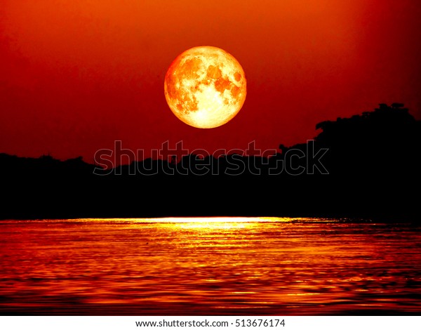 full blood moon and\
moonlight on water surface in river, Elements of this image\
furnished by NASA