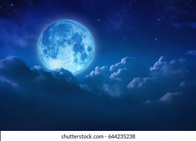 Full blue moon behind cloud over sky and star at night. lunar shine moonlight over cloudy with copy space background for headline text or graphic design. Elements of this image furnished by NASA