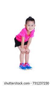 Full Body Of Adorable Asian Child In Sportswear Smiling And Standing With Hands On Her Knees. Healthy Chinese Girl Relax At Studio. Sports And Active Lifestyle. Isolated On White Background.