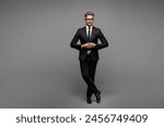 Full body adult confident successful employee business man corporate lawyer he wears classic formal black suit shirt tie work in office look camera isolated on plain grey background studio portrait