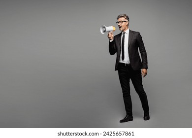 Full body adult employee business man corporate lawyer wear classic formal black suit shirt tie work in office scream in megaphone look aside on area isolated on plain grey background studio portrait - Powered by Shutterstock