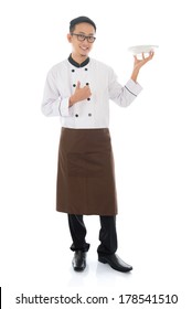 Full Body Asian Chef Holding An Empty Plate Ready For Food, Thumb Up And Standing Isolated On White Background.