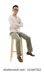 Full Body Asian Man Sitting On A Chair Over White Background