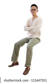 Full body Asian man sitting on a transparent block over white background