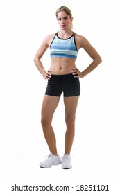 Full Body Of An Attractive Blond Woman In Great Physical Shape Wearing Black Shorts And Workout Top Standing On White With Hands On Hips