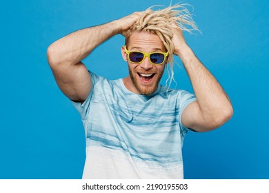 Full Body Attractive Cool Smiling Young Blond Man With Dreadlocks 20s He Wear White T-shirt Sunglasses Isolated On Plain Pastel Light Blue Color Background Studio Portrait. People Lifestyle Concept