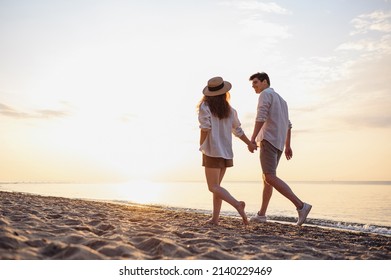 Full body back view young lovely couple two friends family man woman in casual clothes hold hands walking stroll together at sunrise over sea beach ocean outdoor exotic seaside in summer day evening - Powered by Shutterstock