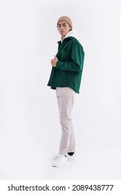 Full Body Back Young Man Wearing A White Hoodie With Green Shirt With Hat In Studio

