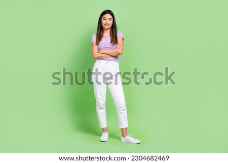 Full body cadre of young confident korean lady crossed arms specialist work in office open studio isolated over green color background