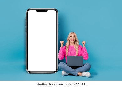 Full body cadre of young overjoyed crazy girl fists up use netbook fast speed internet connection devices isolated on blue color background