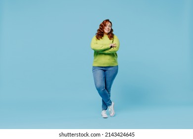 Full body confident happy young chubby overweight plus size big fat fit woman wear green sweater hold hands crossed folded isolated on plain blue background studio portrait. People lifestyle concept - Shutterstock ID 2143424645
