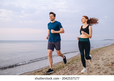 Full body couple young two friends strong sporty sportswoman sportsman woman man wear sport clothes warm up training running on sand sea ocean beach outdoor jog on seaside in summer day cloudy morning - Shutterstock ID 2042537177