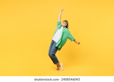 Full body elderly blonde woman 50s years old wear green shirt glasses casual clothes lean back stand on toes with outstretched hands dance isolated on plain yellow background studio. Lifestyle concept - Powered by Shutterstock