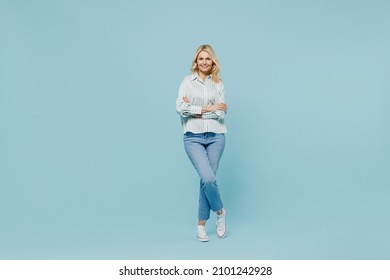 Full Body Elderly Happy Woman 50s Wearing Casual Striped Shirt Looking Camera Hold Hands Crossed Folded Isolated On Plain Pastel Light Blue Color Background Studio Portrait. People Lifestyle Concept