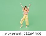 Full body excited little child kid girl 6-7 year old wears casual clothes do winner gesture celebrate clench fists say yes isolated on plain green background Mother