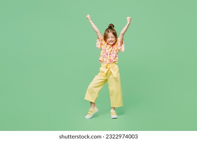 Full body excited little child kid girl 6-7 year old wears casual clothes do winner gesture celebrate clench fists say yes isolated on plain green background Mother's Day love family lifestyle concept - Powered by Shutterstock