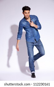 Full Body Of A Fashion Man Holding His Jeans Shirt By Its Collar