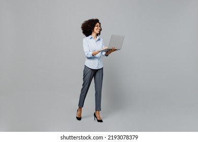 Full Body Fun Successful Young Employee Business Corporate Lawyer Woman Of African American Ethnicity In Classic Formal Shirt At Office Hold Use Work On Laptop Pc Computer Isolated On Grey Background