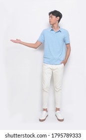 Full Body Handsome Young Man Isolated Wearing Blue Polo Shirt With White Pants And White Sneakers With Handshake As Greeting And Welcoming 