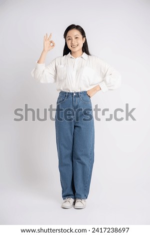 Full body image of Asian businesswoman posing on a white background