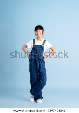 Full body image of an Asian girl posing on a blue background