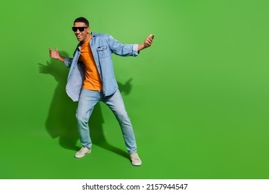 Full body image of good mood young man have fun relaxing on weekend in nightclub isolated on green color background - Shutterstock ID 2157944547