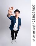 Full body image of a young man posing on a white background