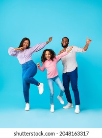 Full Body Length Of Excited Young Black Family Of Three Dancing Fooling Around, Having Fun. Happy African American Man, Woman And Girl Enjoying Favorite Music Together At Blue Studio, Free Copy Space