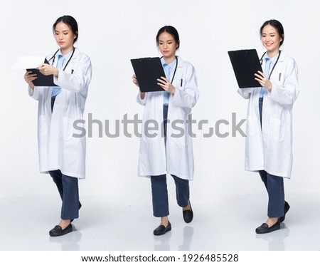 Full body length Figure snap of 20s Asian Woman wear Doctor White uniform pants, stethoscope and walk with paper chart, white Background isolated
