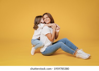 Full Body Length Happy Woman In Basic White T-shirt Have Fun Sit On Floor Child Baby Girl 5-6 Years Old Mom Mum Little Kid Daughter Isolated On Yellow Color Background Studio Mother's Day Love Family