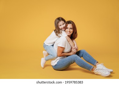 Full body length happy woman in basic white t-shirt have fun sit on floor child baby girl 5-6 years old Mom mum little kid daughter isolated on yellow color background studio Mother's Day love family - Shutterstock ID 1959785383