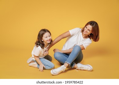 Full Body Length Happy Woman In Basic White T-shirt Have Fun Sit On Floor With Child Baby Girl 5-6 Years Old Mom Little Kid Daughter Isolated On Yellow Color Background Studio Mother's Day Love Family