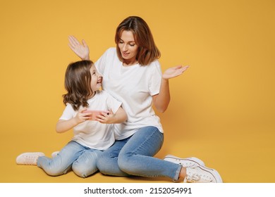 Full Body Length Happy Woman In White T-shirt Have Fun Sit Use Cell Phone Child Baby Girl 5-6 Years Old Mom Mum Little Kid Daughter Isolated On Yellow Color Background Studio Mother's Day Love Family