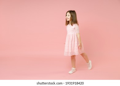 Full body length little cute kid girl 5-6 years old wears rosy dress have fun walk go step isolated on pastel pink background child studio portrait. Mother's Day love family people lifestyle concept - Shutterstock ID 1931918420