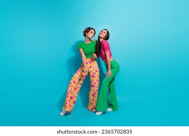 Full body length photo of two coquette flirting girls friendship posing stunning models romantic night isolated on blue color background - Shutterstock ID 2365702835