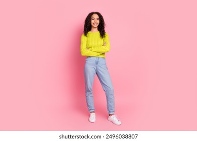 Full body length photo of youth girl with curly brunette hair posing in casual outfit folded arms smiling isolated on pink color background - Powered by Shutterstock