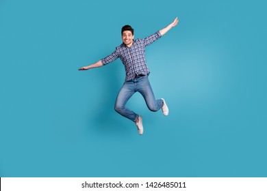 Full body length size photo of crazy humorous handsome carefree careless dreamy optimistic generation y millennial he him guy stretching arms hands to sides isolated pastel background