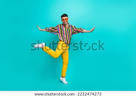 Full body length size of young hipster guy student popular celebrity wear sunglass enjoy dancing tiptoe overjoyed isolated on cyan color background