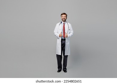 Full body male doctor confident cheerful smiling man wearing white medical gown suit work in hospital look camera isolated on plain grey color background studio portrait. Healthcare medicine concept - Shutterstock ID 2254802651